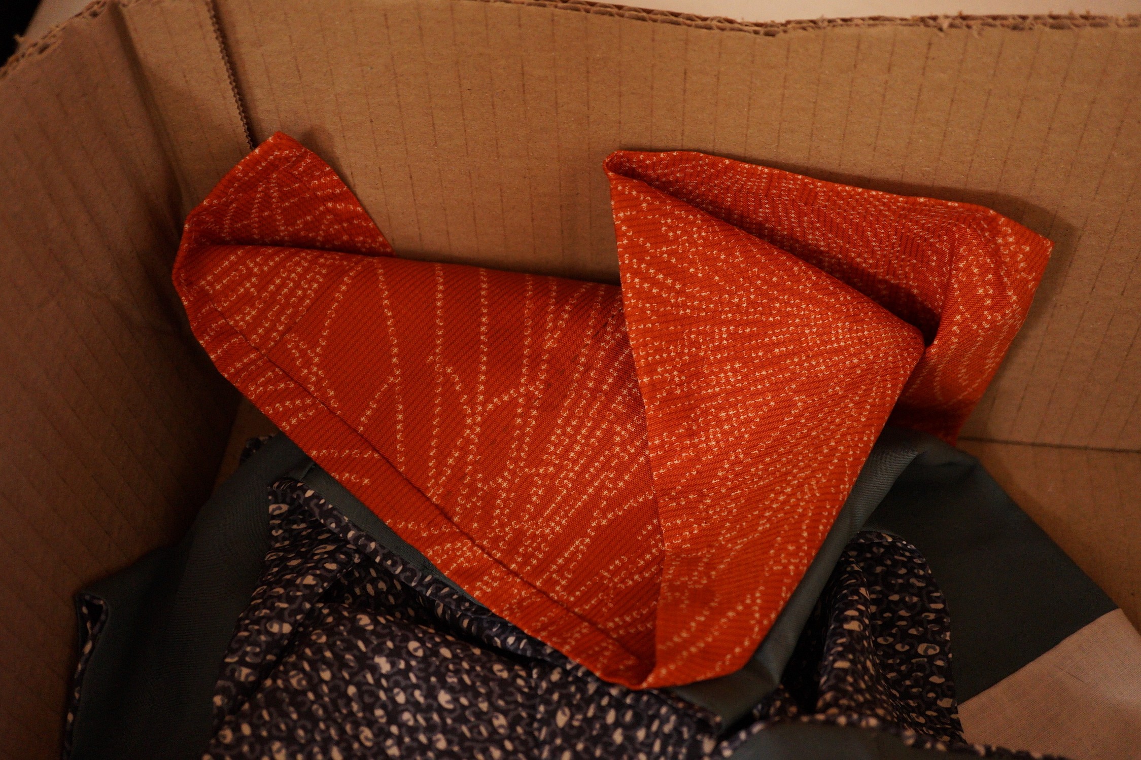 An assortment of clothing: two kimonos and a throw